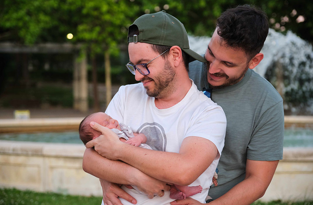 Two gay men with their newborn.