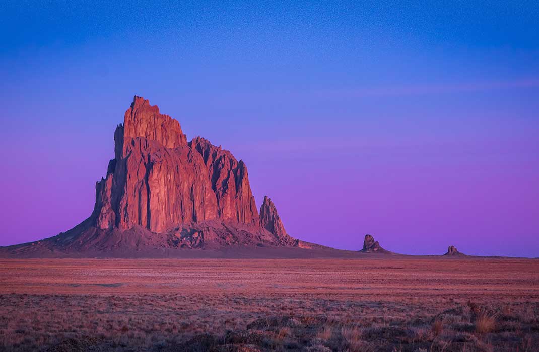 The Shiprock rock formation at sunrise in Shiprock, New Mexico