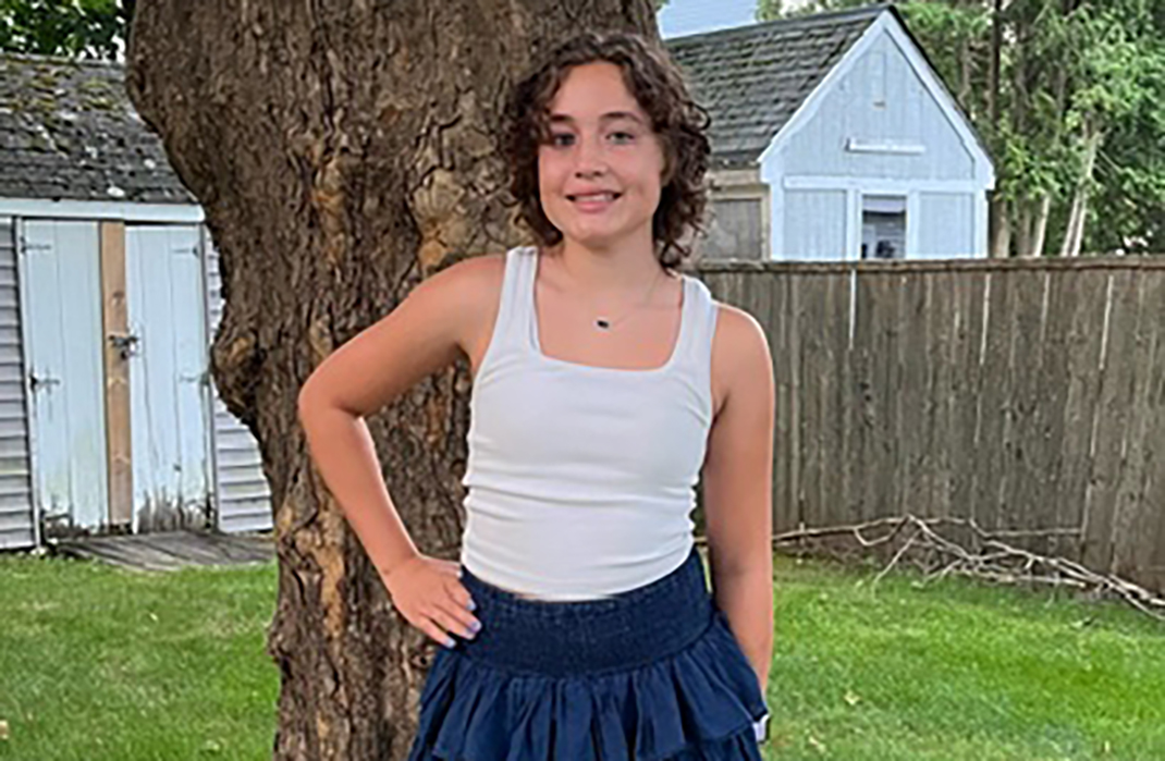 Young girl outside with her hand on her hip