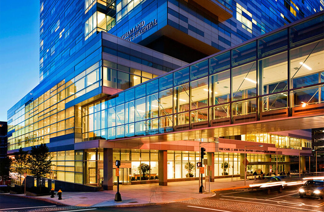 The exterior of Brigham and Women's hospital lit up in the dusk.