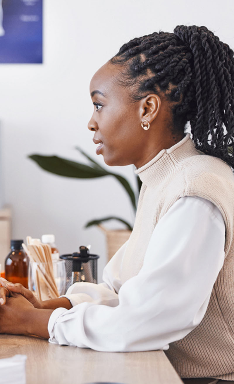 female african american patient talking to female doctor in office 