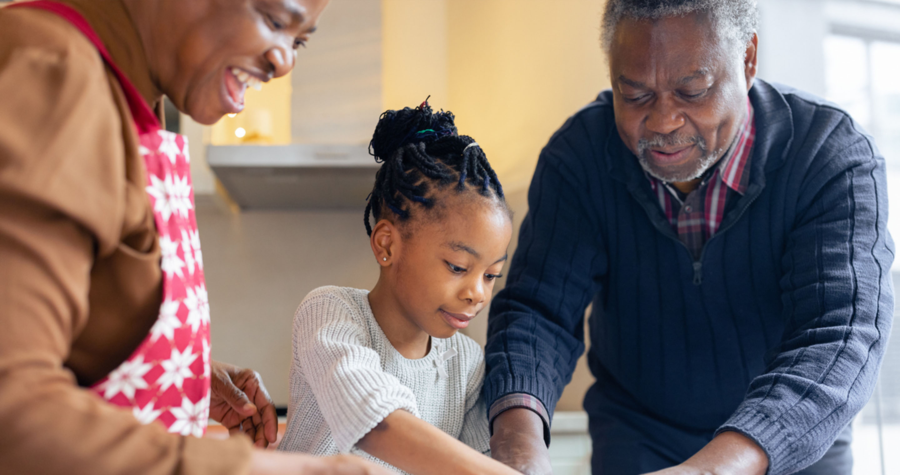 family making cookies in kitchen