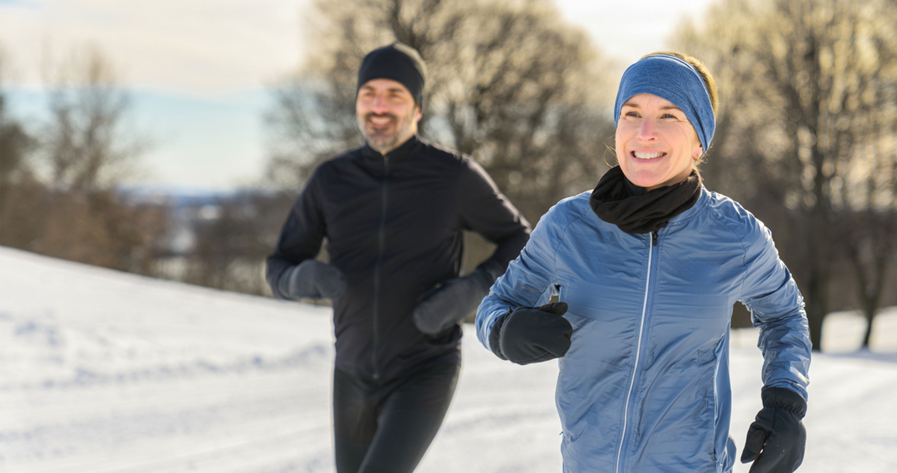 man and woman walking outside during winter