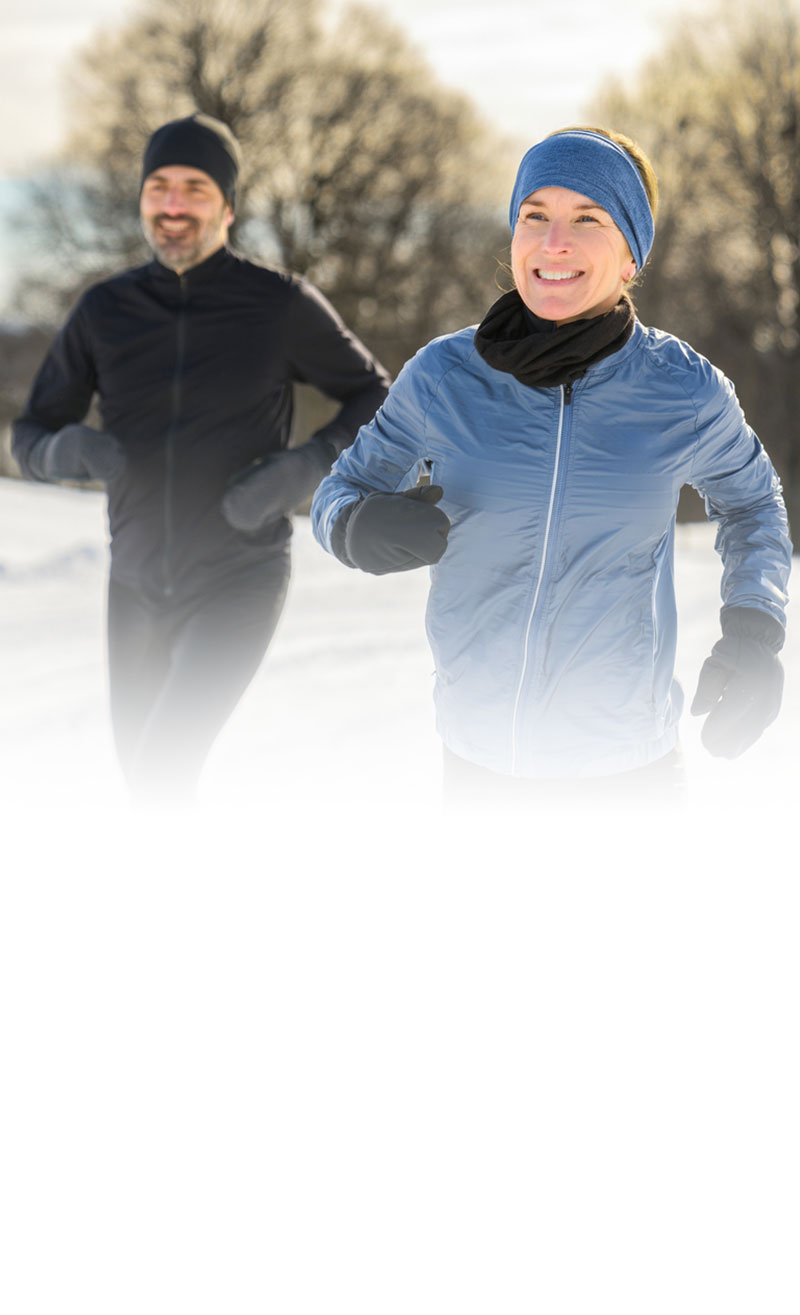 man and woman walking outside during winter