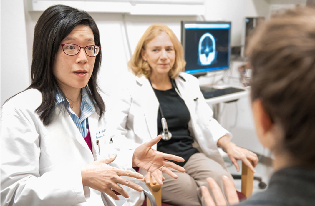 Helen Shih, MD talking with patient in clinic