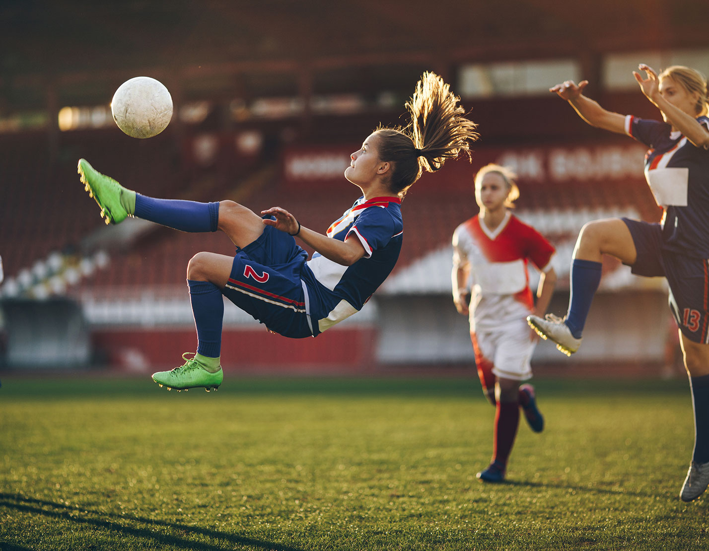 female soccer players in action on field