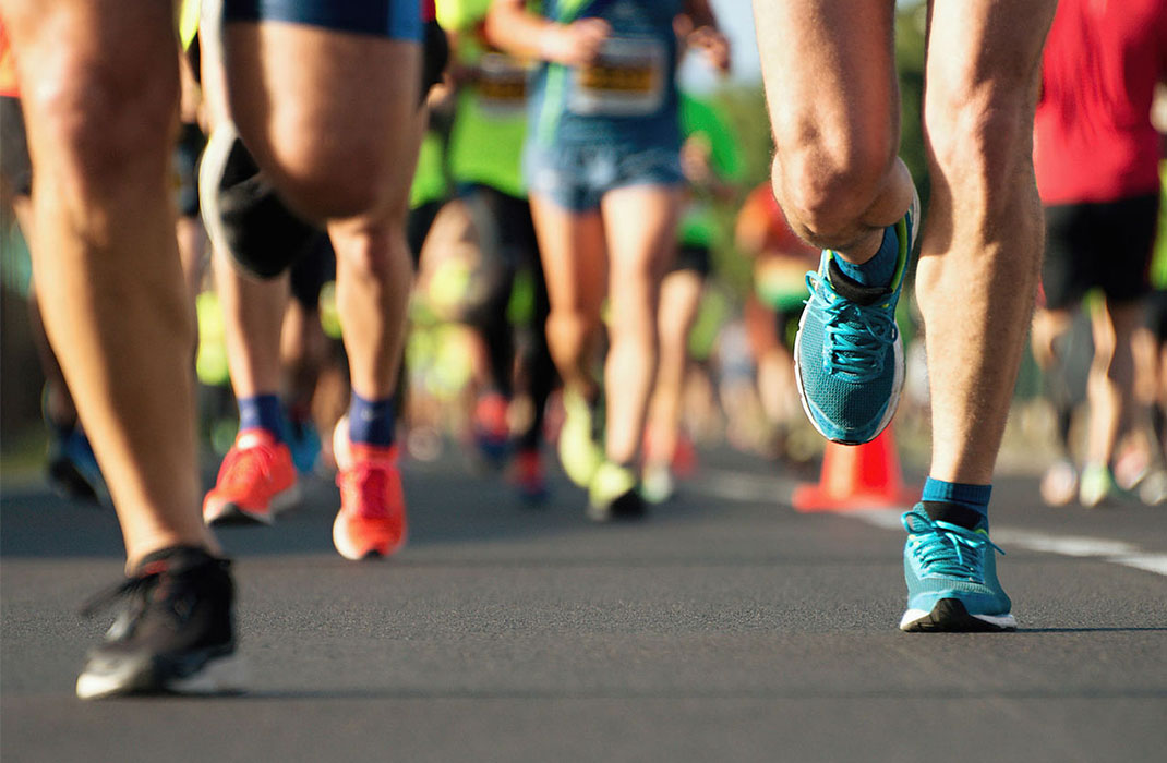 close up of runners legs during road race