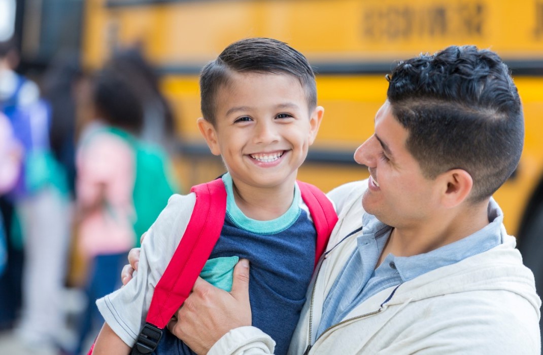 Dad and boy with school bus