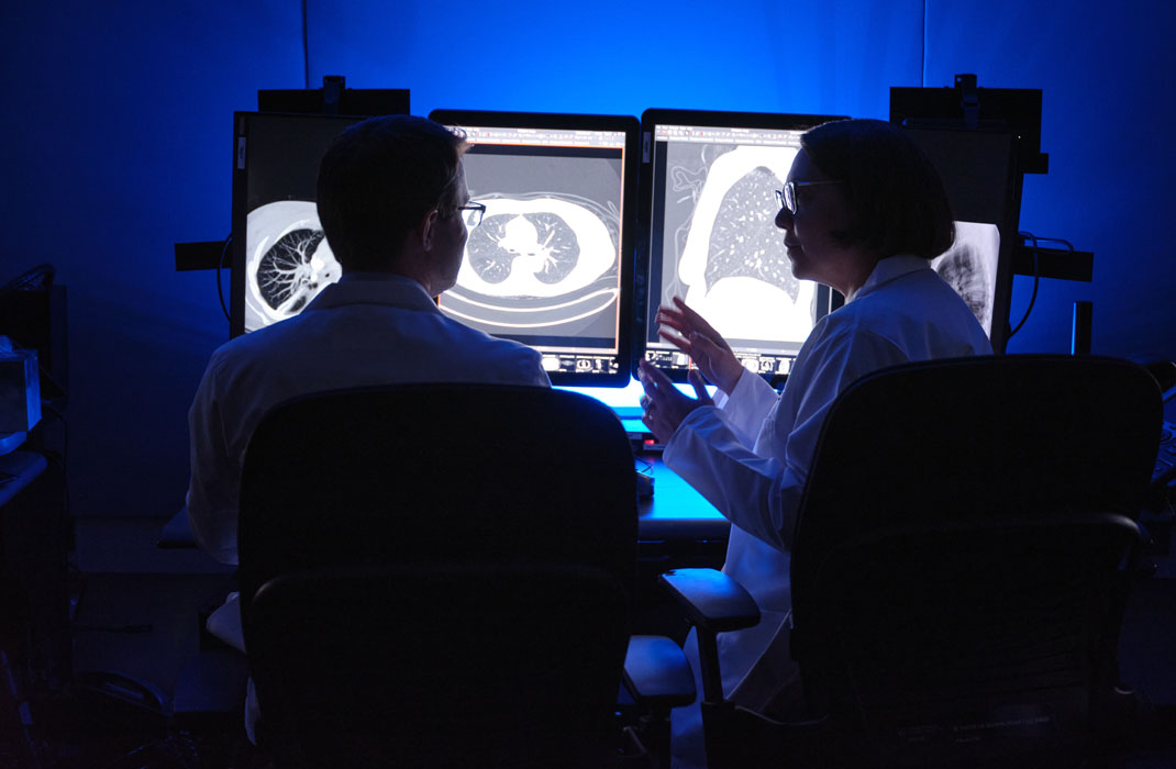 Drs. Fintelmann and Sequist looking at CT scans of the chest