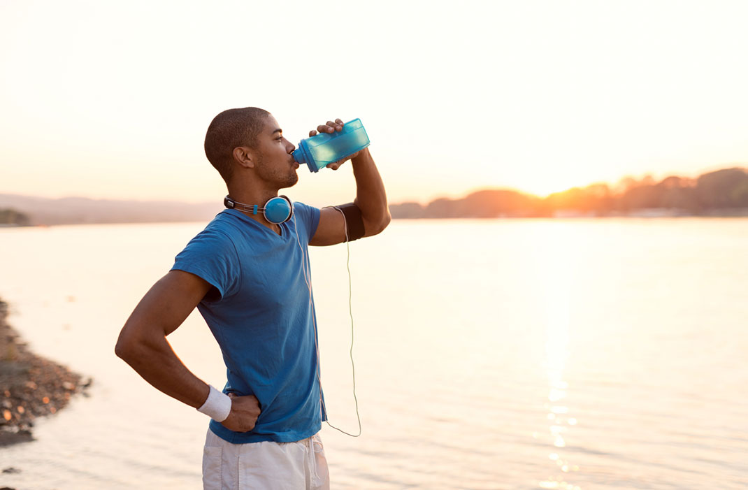 Runner stays hydrated to help prevent cross country injuries. 