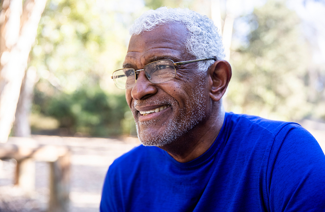 A smiling man wearing glasses.