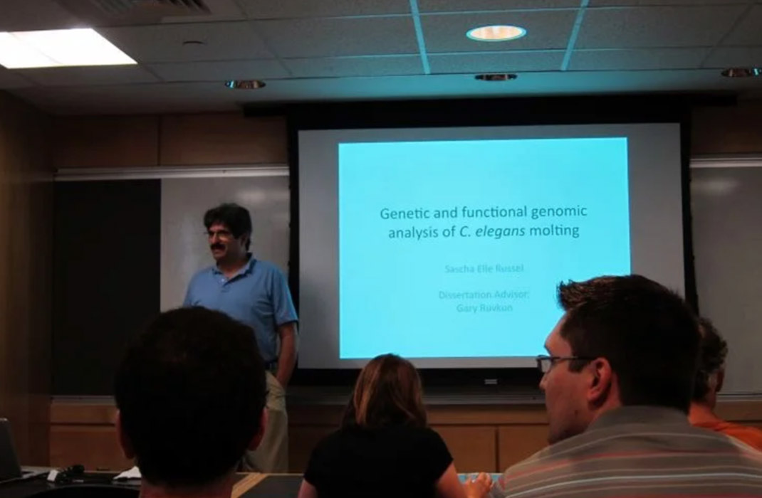 A lecture room with a PowerPoint presentation up on screen