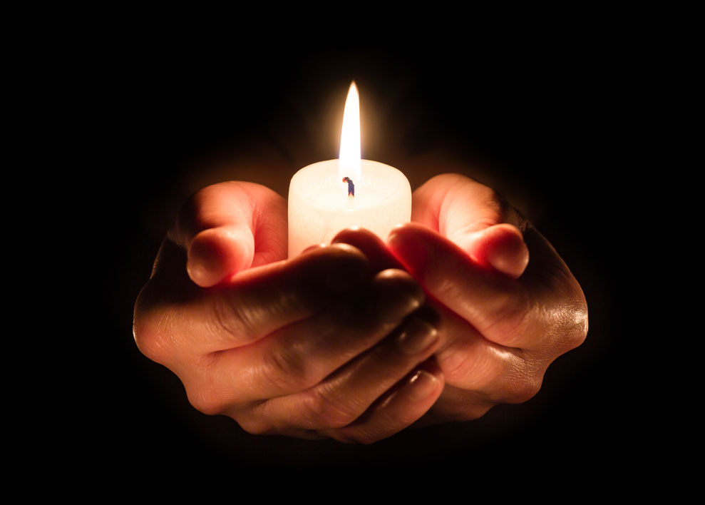 1284752826 Lighting a memorial candle is one way to honor a deceased love one during the holidays.