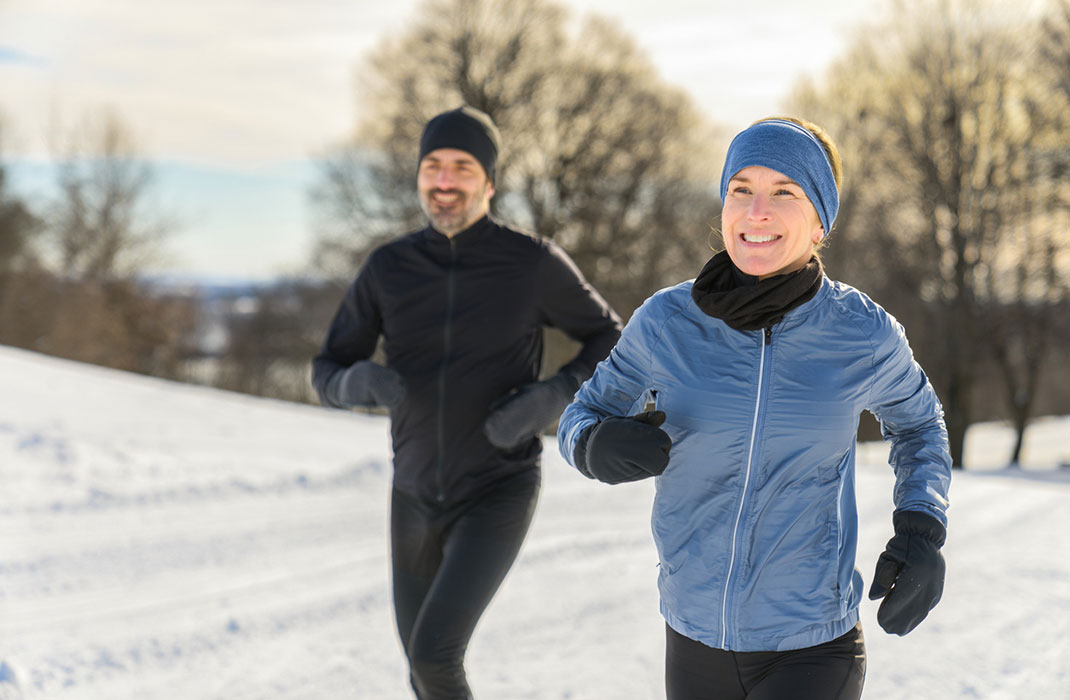 Two people jogging in snow.