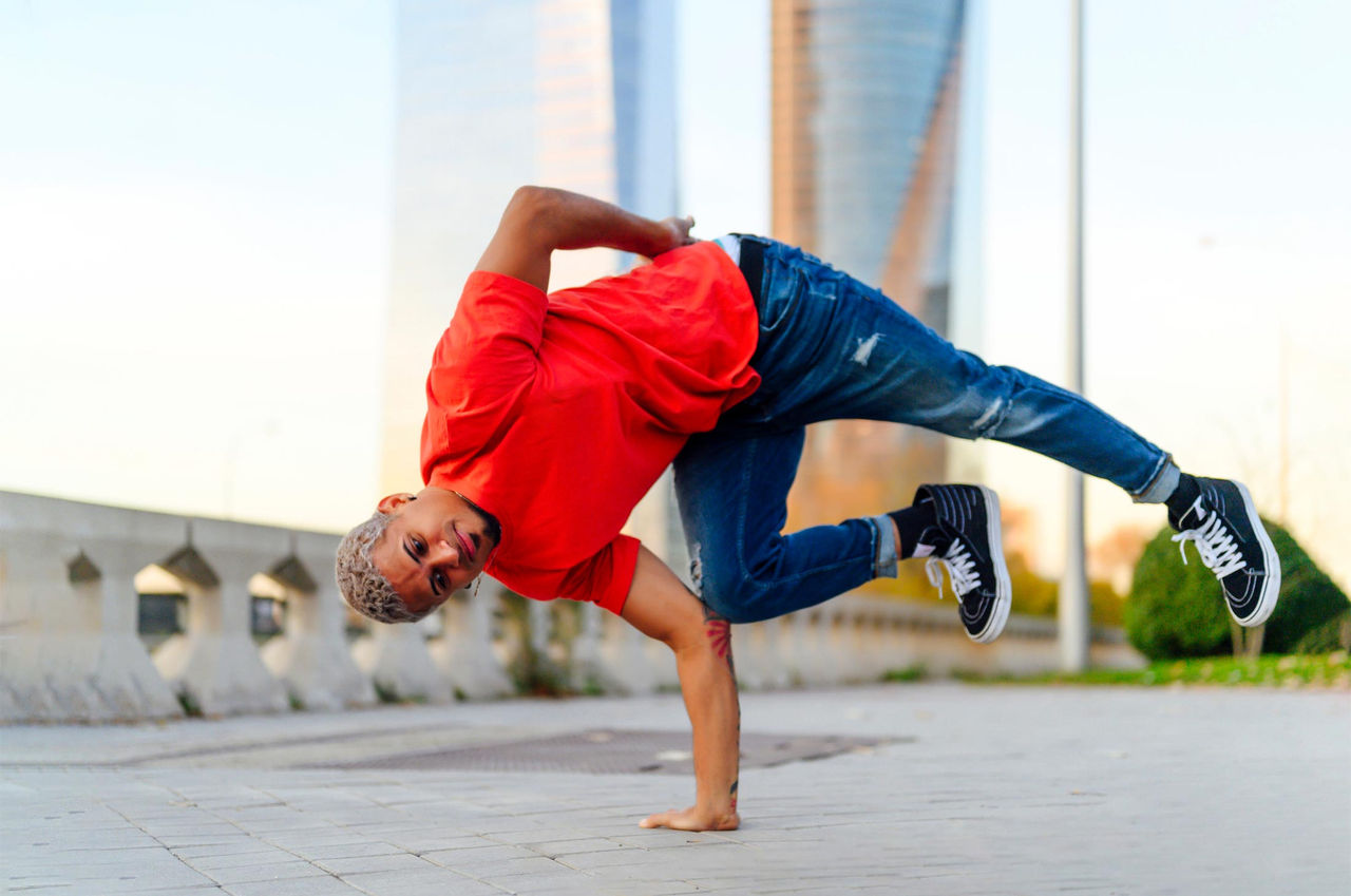 A male dancer practices his breakdancing routine outside