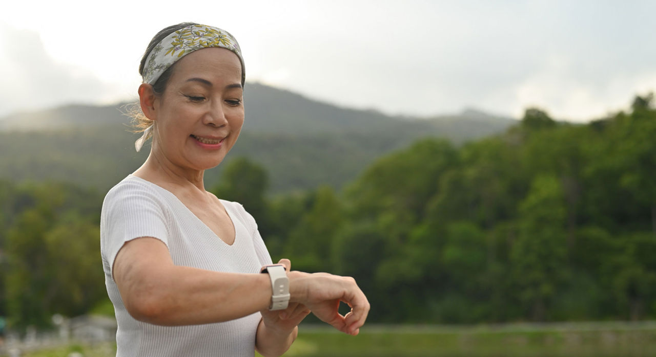 A woman checks her pulse on a smart watch