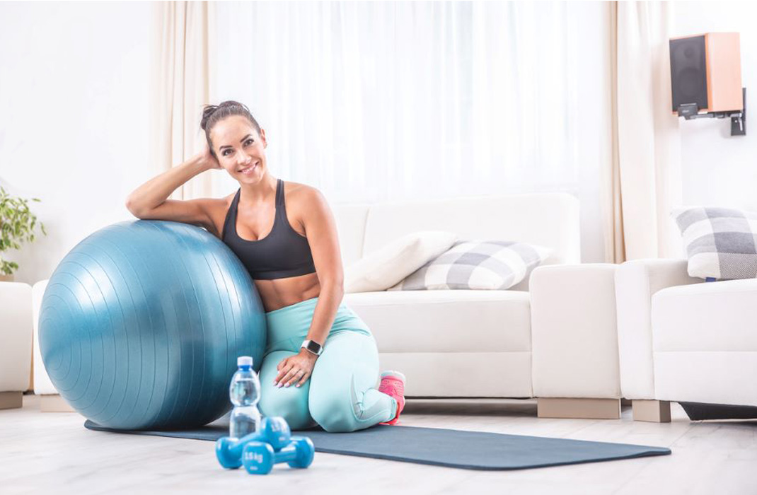 A woman prepares to strengthen her pelvic floor with exercises at home. 