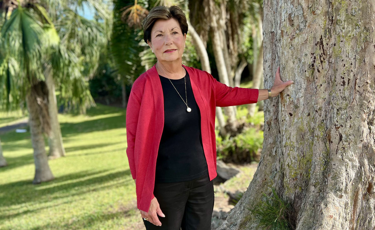 Penelope Perry leaning against a tree, posing for a picture.