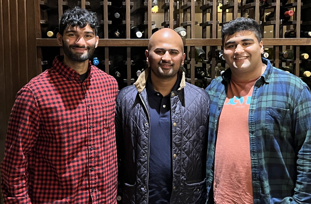 Rohan (center) with his two brothers in 2022.