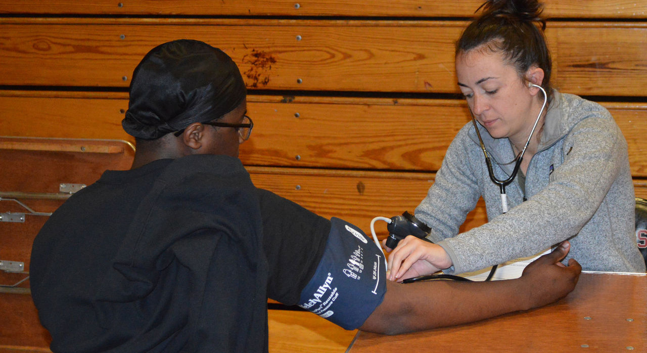 MGB Sports Medicine staff member provides a physical exam to an athlete from Boston Public Schools.