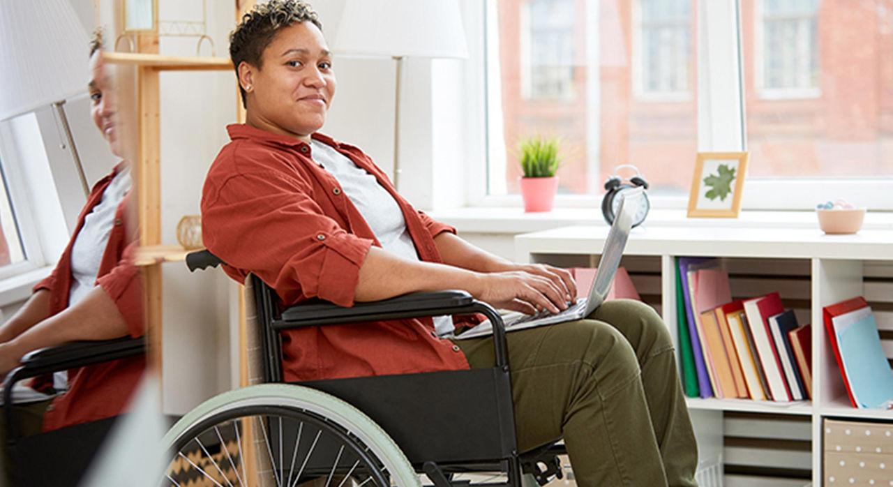 woman in wheelchair using laptop