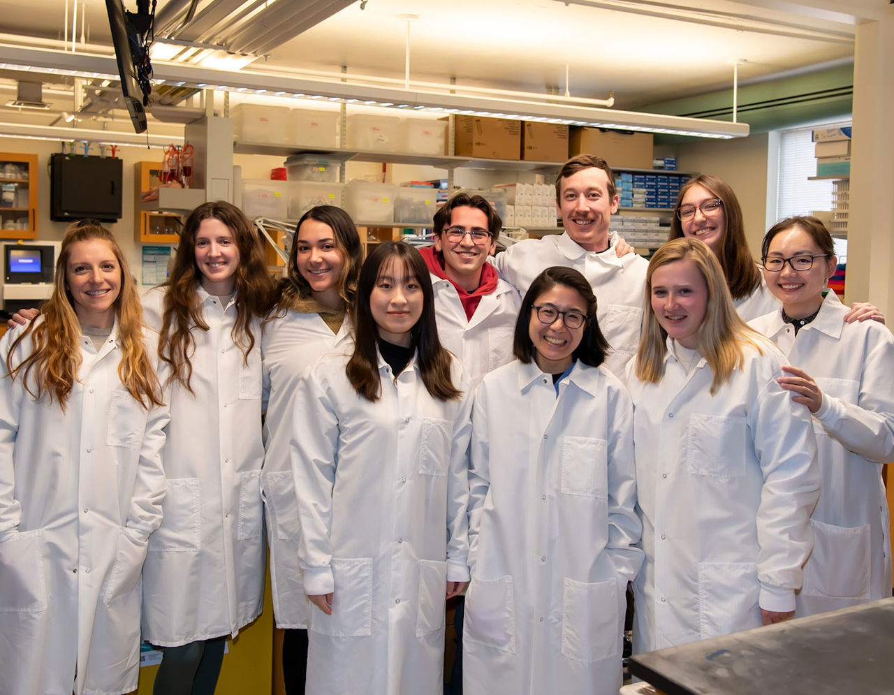 MLS students in lab coats posing in their laboratory.
