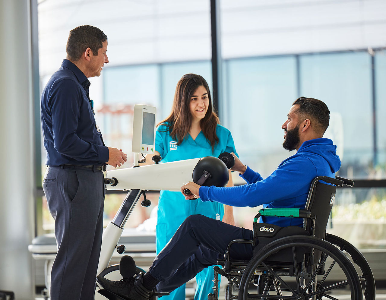 Healthcare providers working with patient on physical therapy