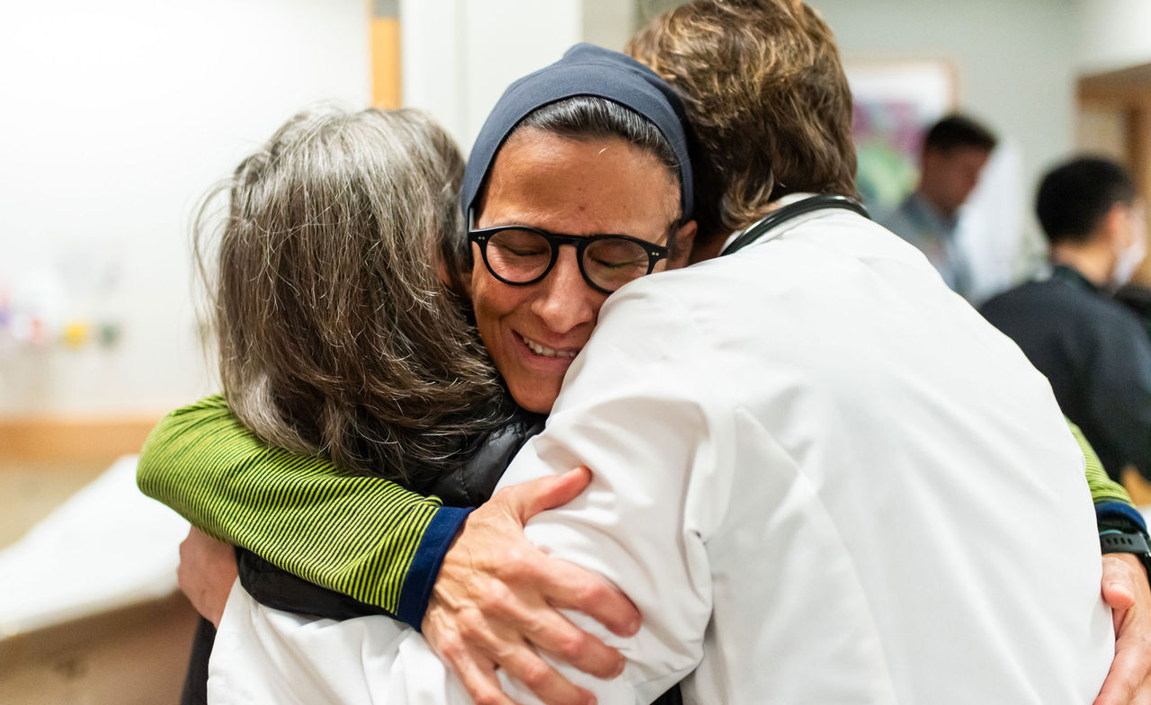 Daphne Haas-Kogan, MD hugging patient in clinic