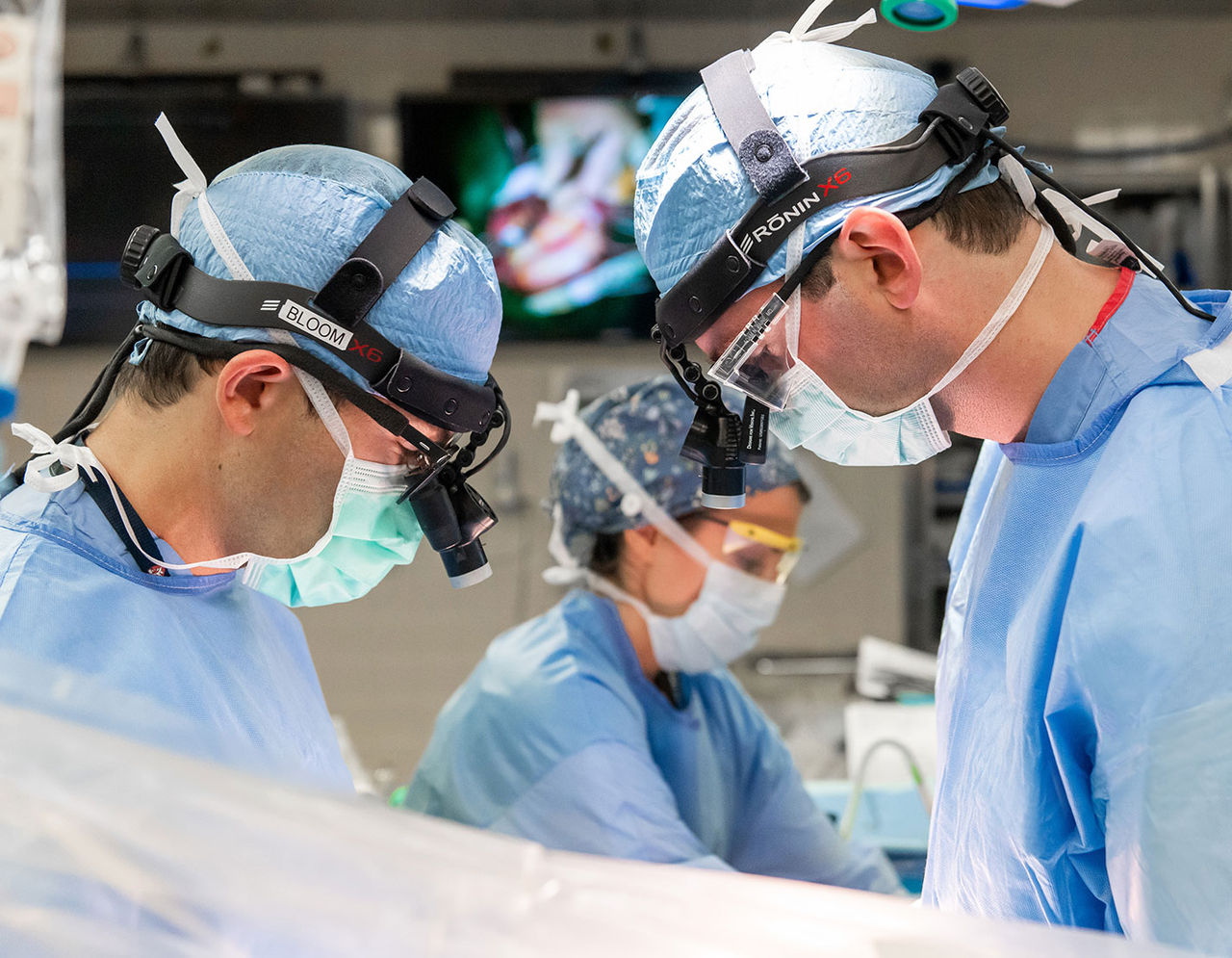 close up of heart providers performing surgery on patient in operating room