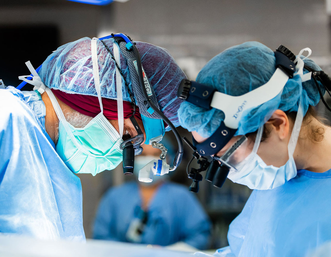 close up of cardiac surgeons operating on patient in an exam room
