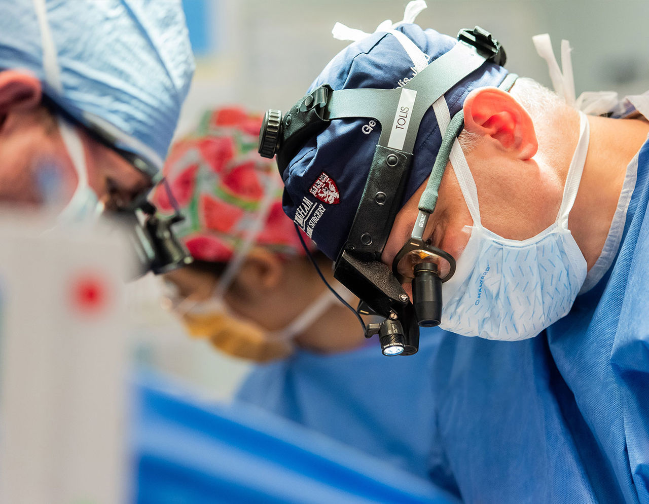 close up of heart surgeons wearing eye magnifiers in operating room