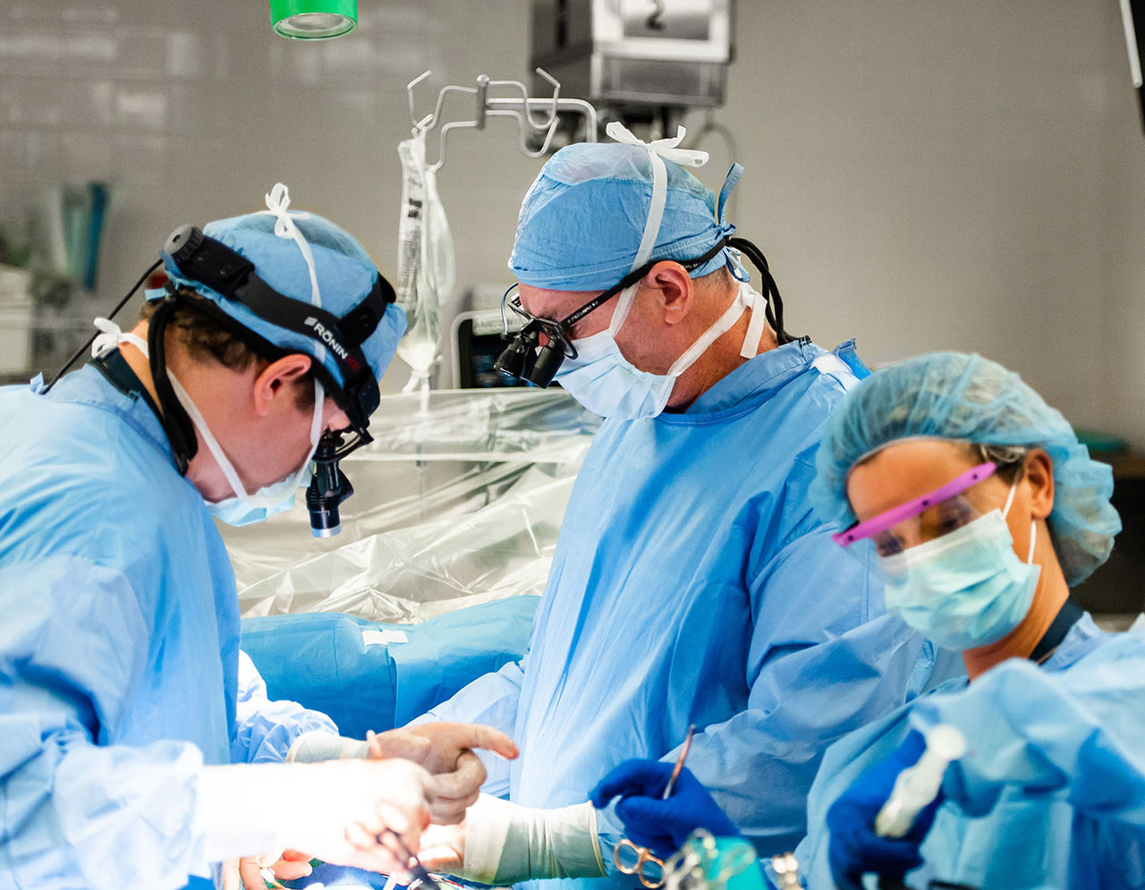 heart providers performing surgery on patient in operating room
