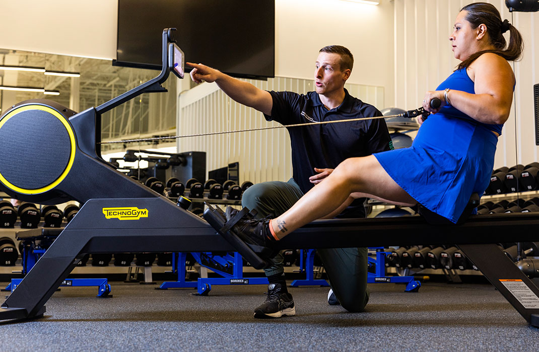 Mark Murphy with female client at rowing machine