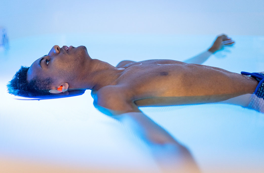 male athlete floating in saltwater tank