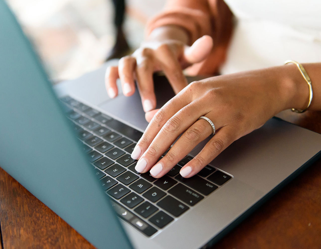 Hands using laptop to read about policy.